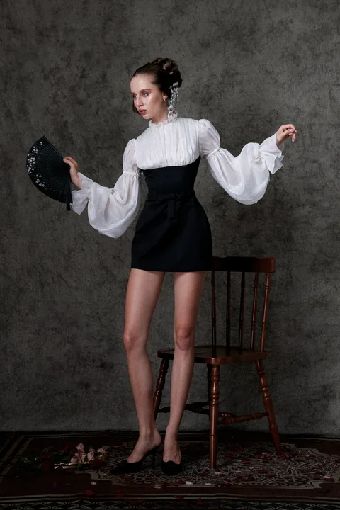 Karolina Juza — studio editorial on a painted backdrop