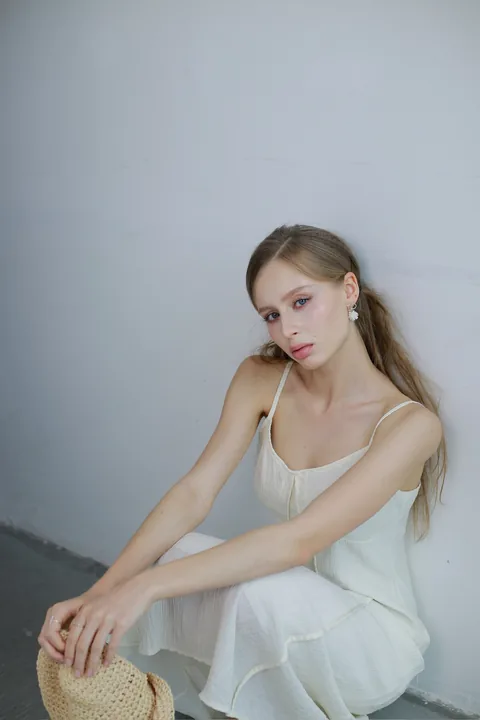 Karolina Juza — clean looks against a pale wall